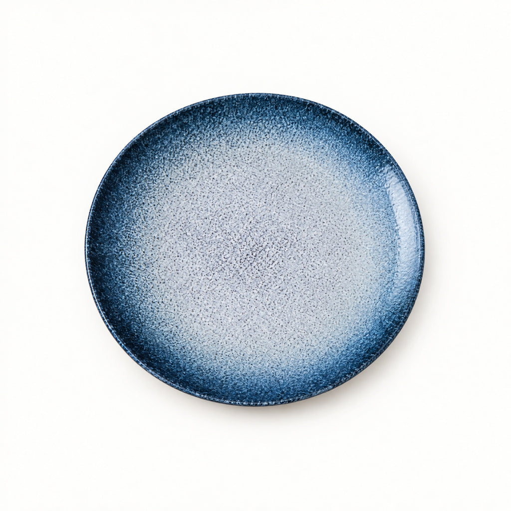 Japanese ceramic shallow plate with a deep blue rim fading to a pale snow-speckled centre