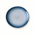 Japanese ceramic shallow plate with a deep blue rim fading to a pale snow-speckled centre