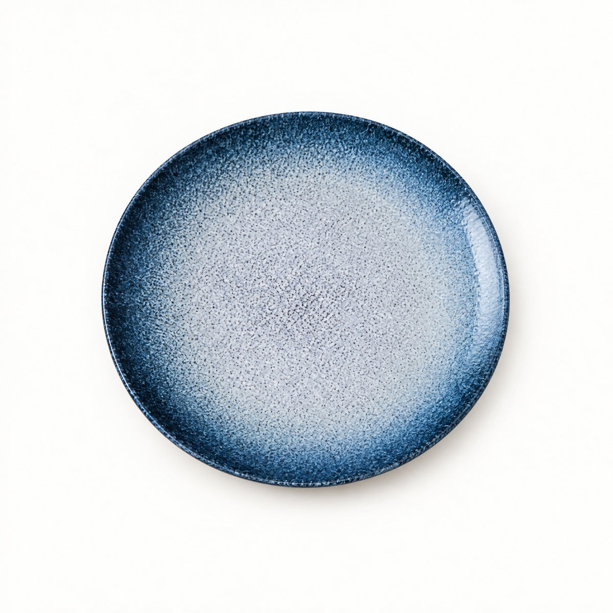 Japanese ceramic shallow plate with a deep blue rim fading to a pale snow-speckled centre