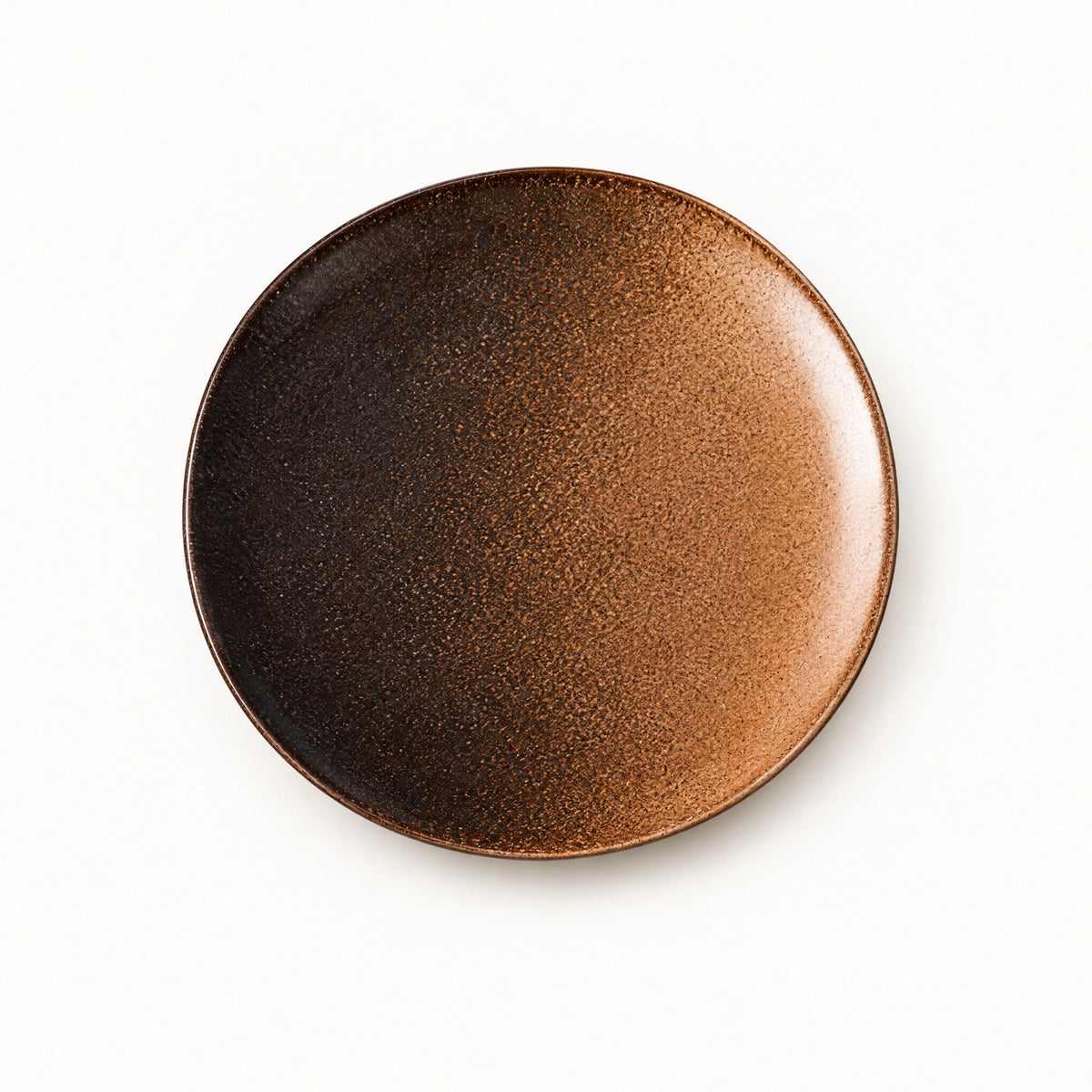 Japanese ceramic shallow plate in a warm copper-brown glaze fading to dark chocolate at the rim