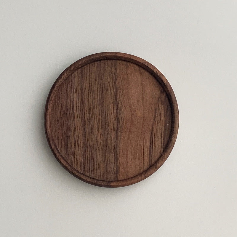 Solid walnut wood coasters with natural grain on a table — view 12