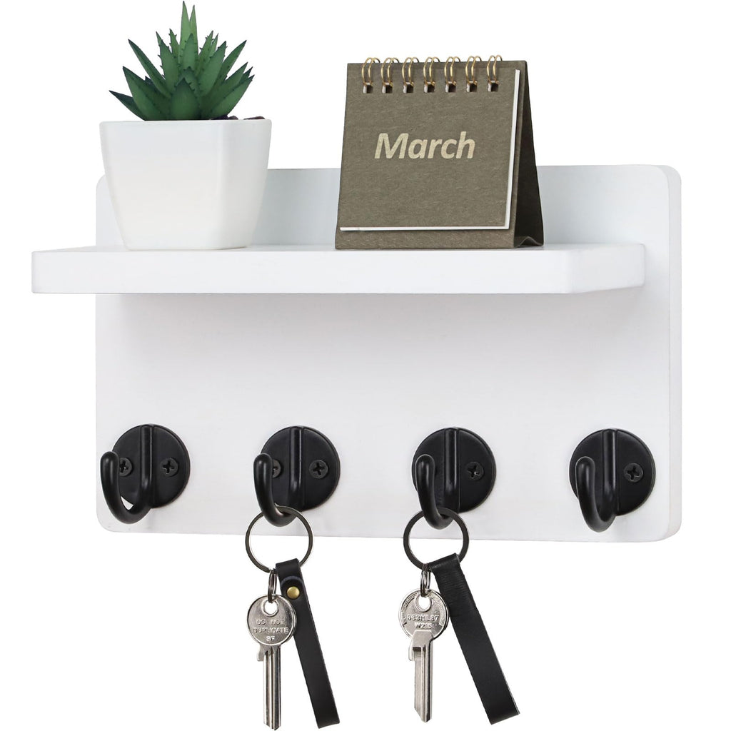 White wooden wall-mounted key holder with hooks and display shelf in entryway — alternate view