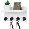 White wooden wall-mounted key holder with hooks and display shelf in entryway — alternate view