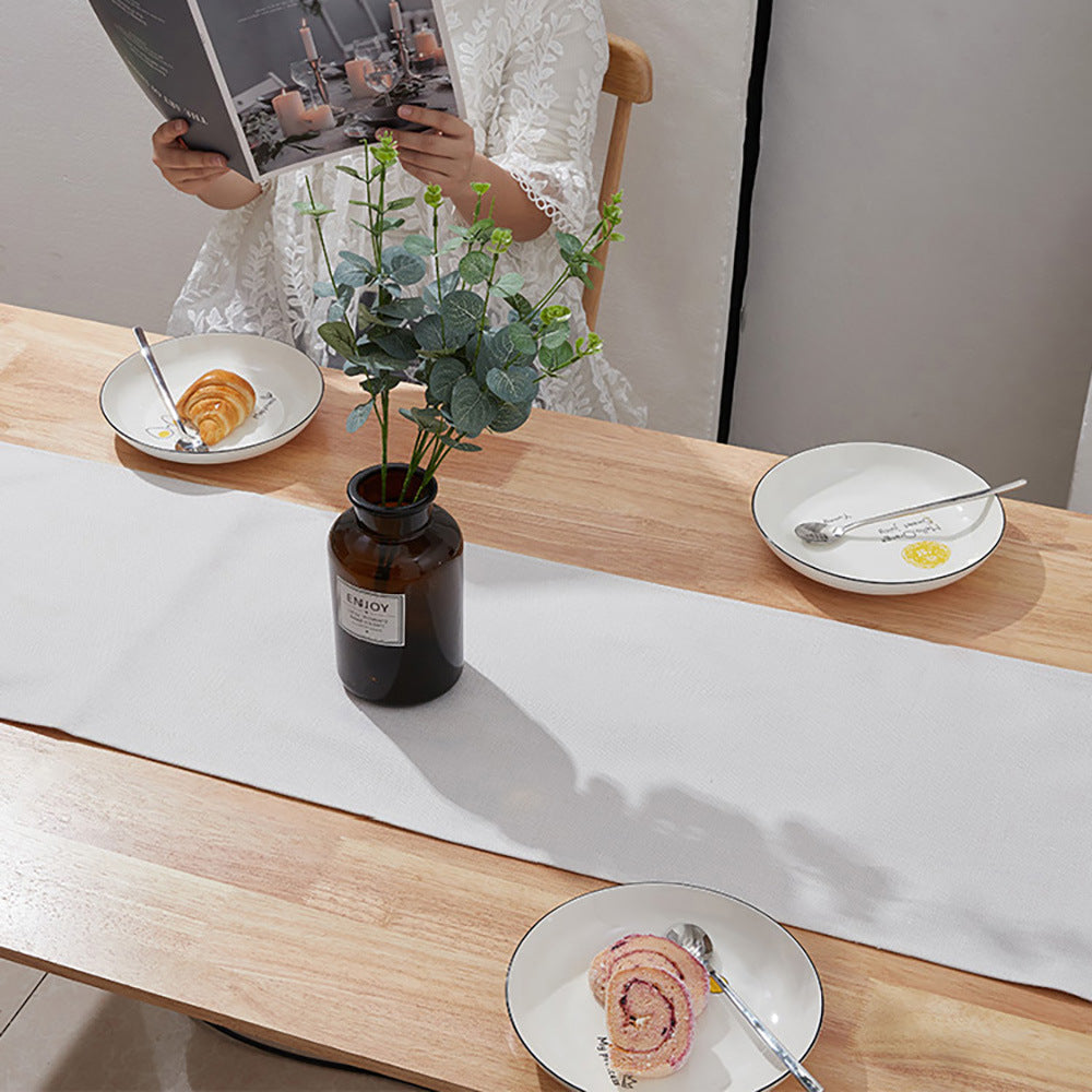 Warm white linen-weave table runner styled on a wooden dining table — view 9