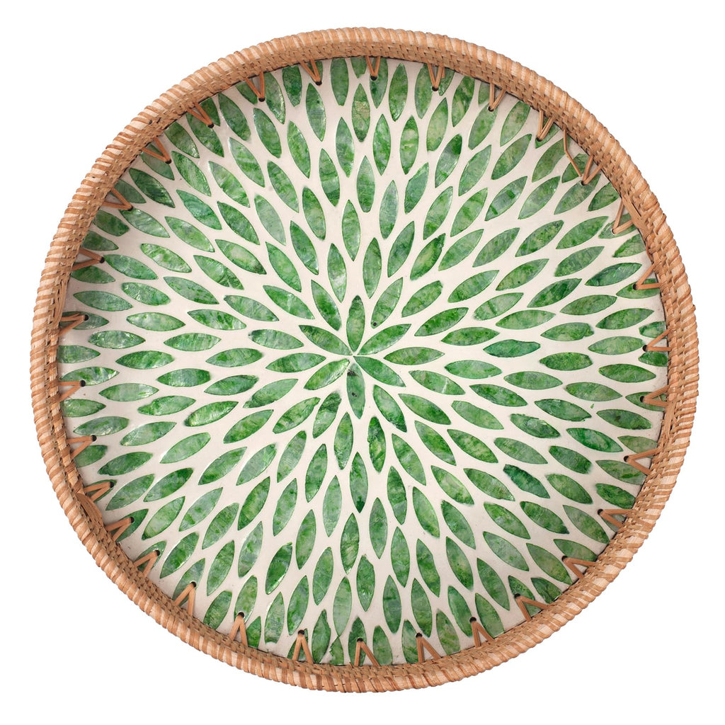Round woven rattan serving tray with mother of pearl inlay on a coffee table