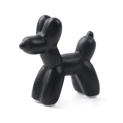 Glossy black ceramic balloon dog sculpture on a shelf