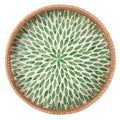 Round woven rattan serving tray with mother of pearl inlay on a coffee table — alternate view