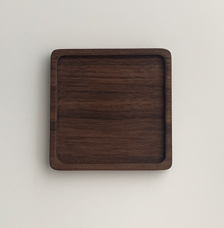 Solid walnut wood coasters with natural grain on a table — view 13