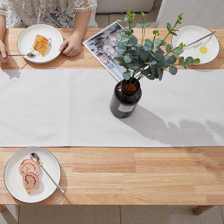 Warm white linen-weave table runner styled on a wooden dining table — view 8