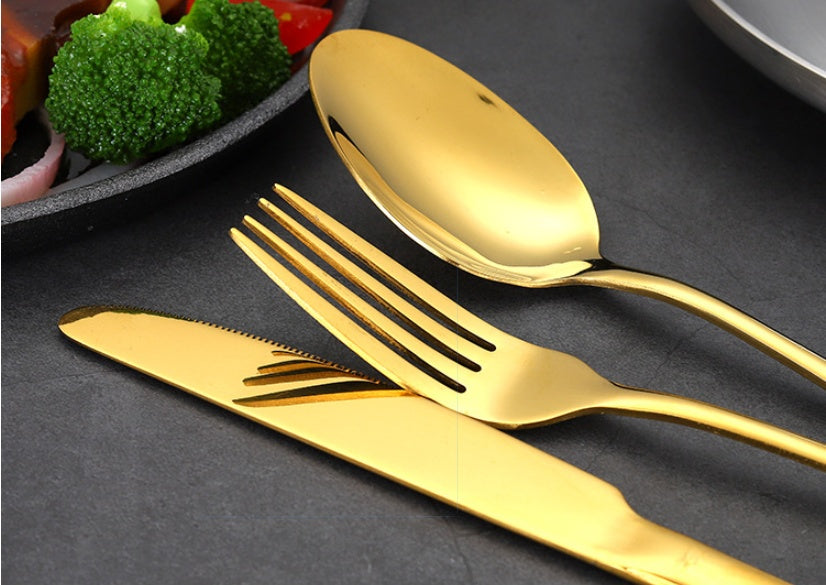 24-piece mirror-gold stainless flatware set in gold gift box — scale view