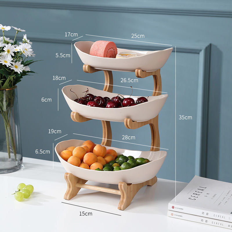 Tiered fruit and dessert stand styled with fresh fruit on kitchen counter — view 6