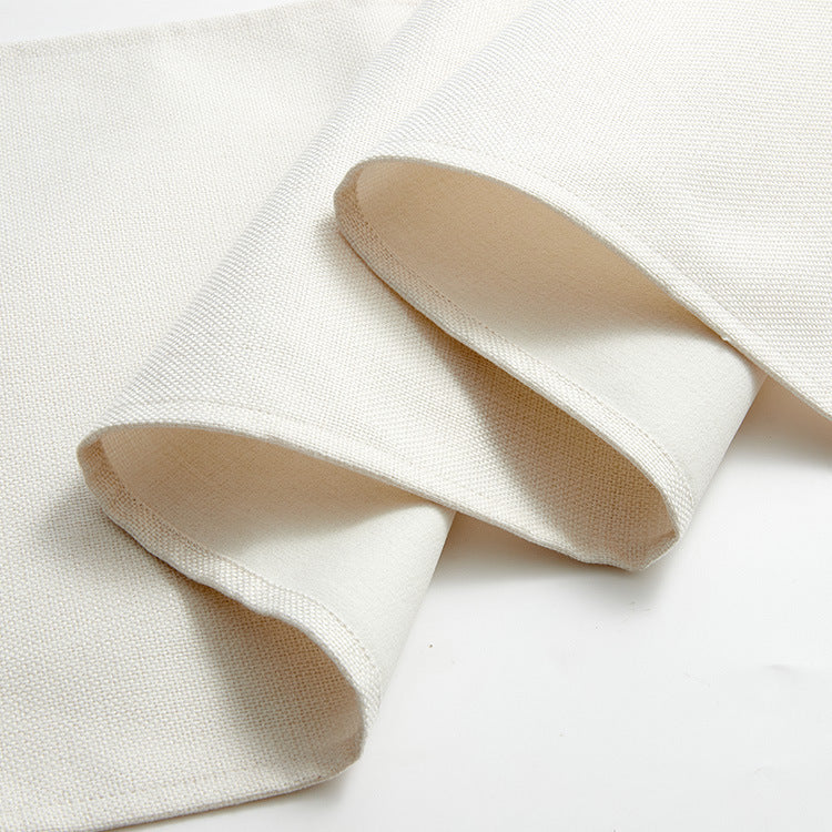 Warm white linen-weave table runner styled on a wooden dining table — view 6