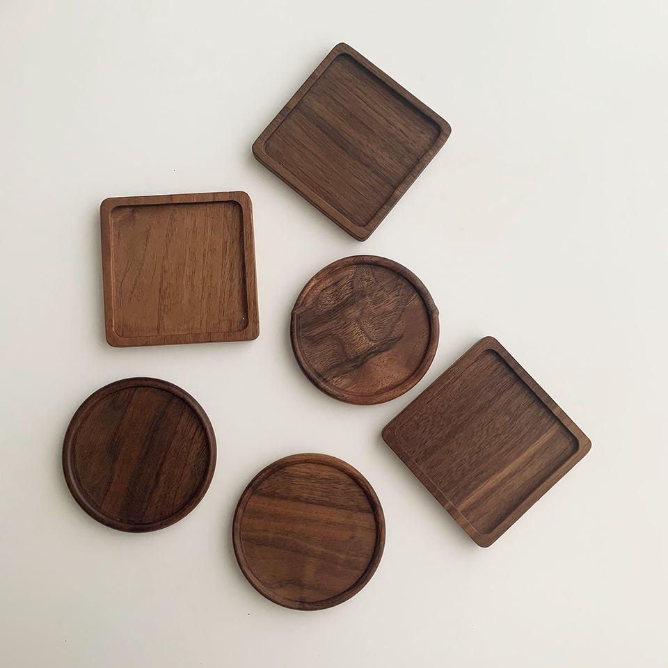 Solid walnut wood coasters with natural grain on a table — view 18