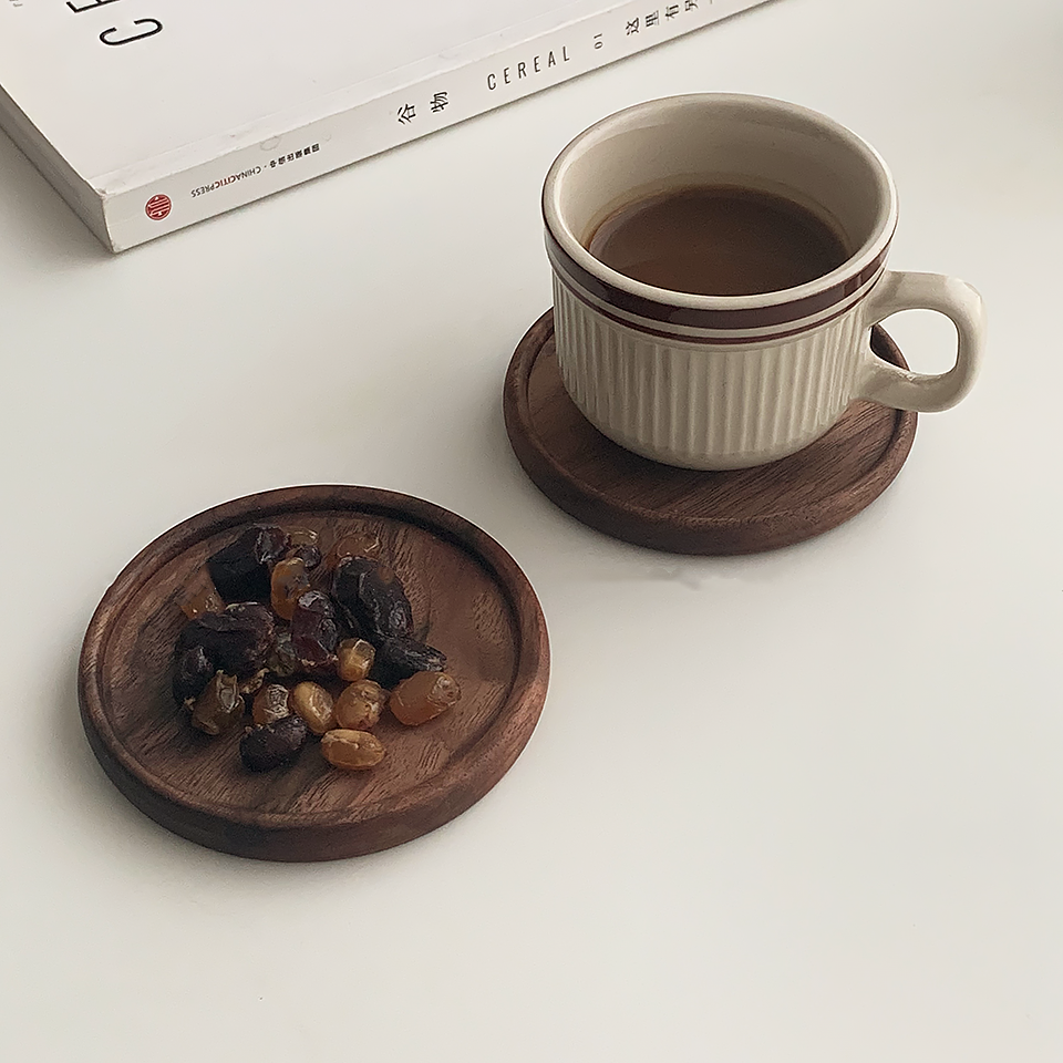 Solid walnut wood coasters with natural grain on a table — view 20