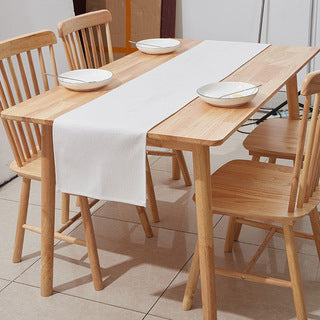 Warm white linen-weave table runner styled on a wooden dining table — scale view