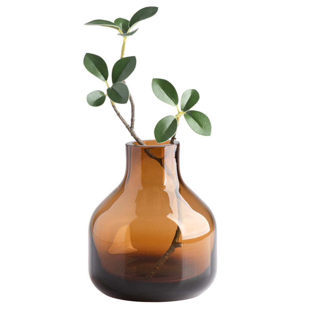 Handblown amber glass bud vase with a single stem on a shelf — alternate view