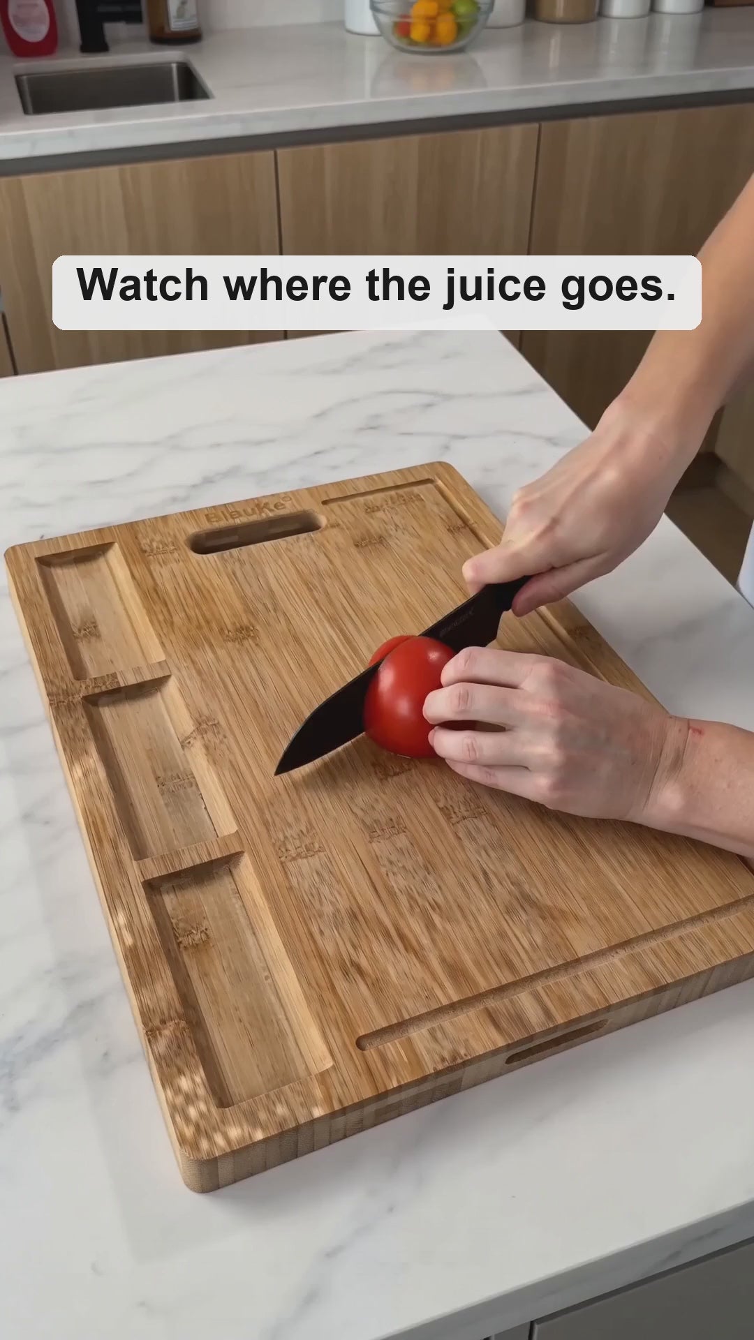 XL bamboo cutting and serving board in use: chopping vegetables into the built-in compartments, juice collecting in the deep groove