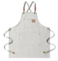 Artisan canvas kitchen apron with adjustable straps and front pockets
