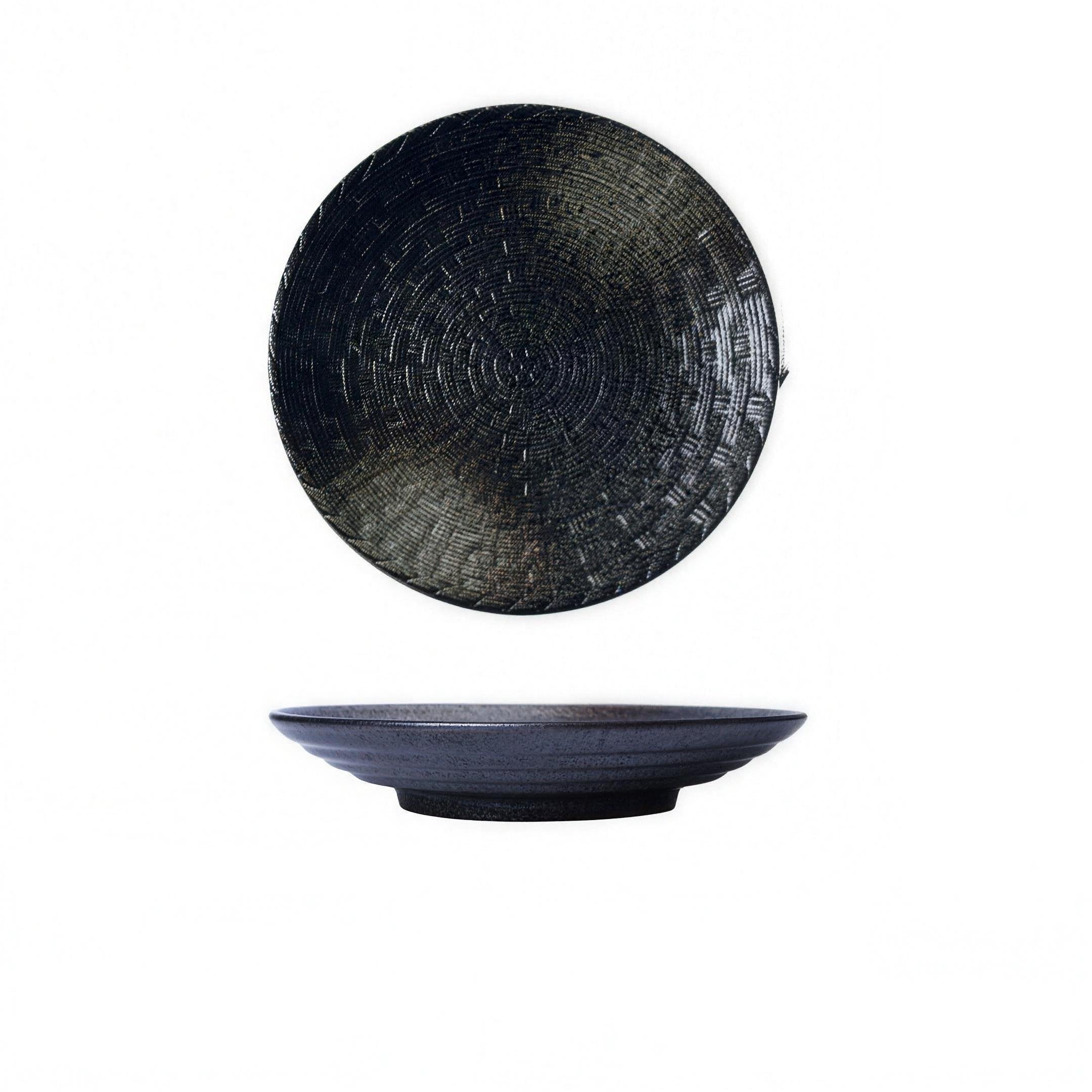 Woven-texture glazed ceramic dinner plate in black on a set table — detail view