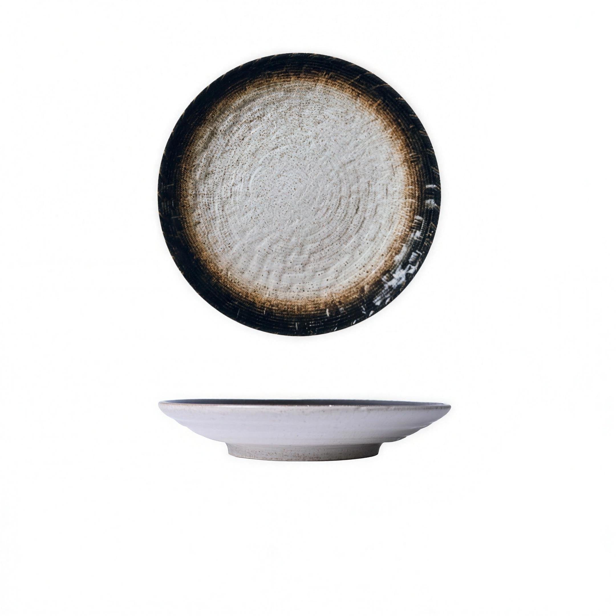 Woven-texture glazed ceramic dinner plate in black on a set table — in use