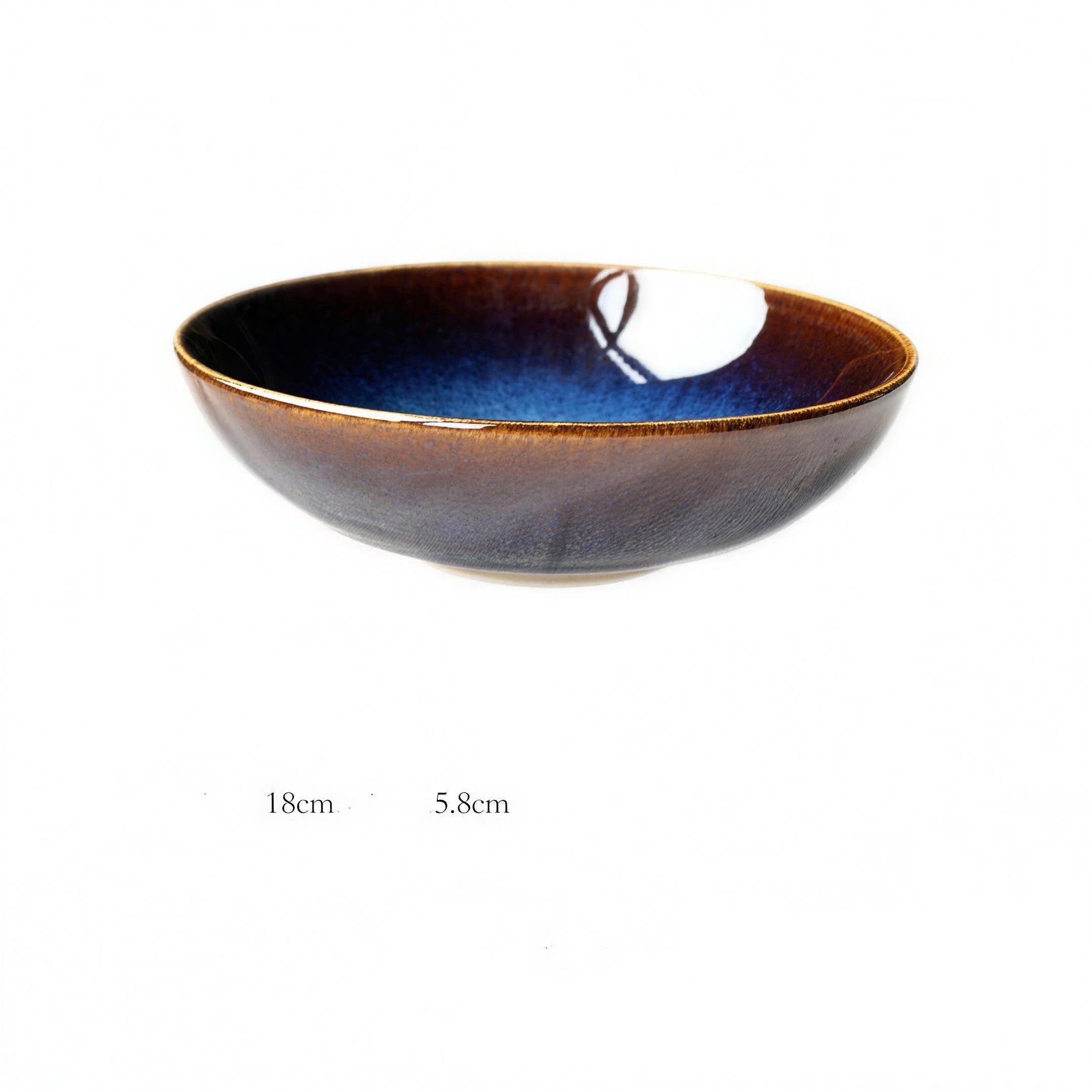 Kiln-glazed blue porcelain shallow dish on a neutral table — alternate view