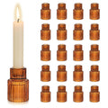 Amber ribbed glass taper candle holders set on a dinner table — alternate view