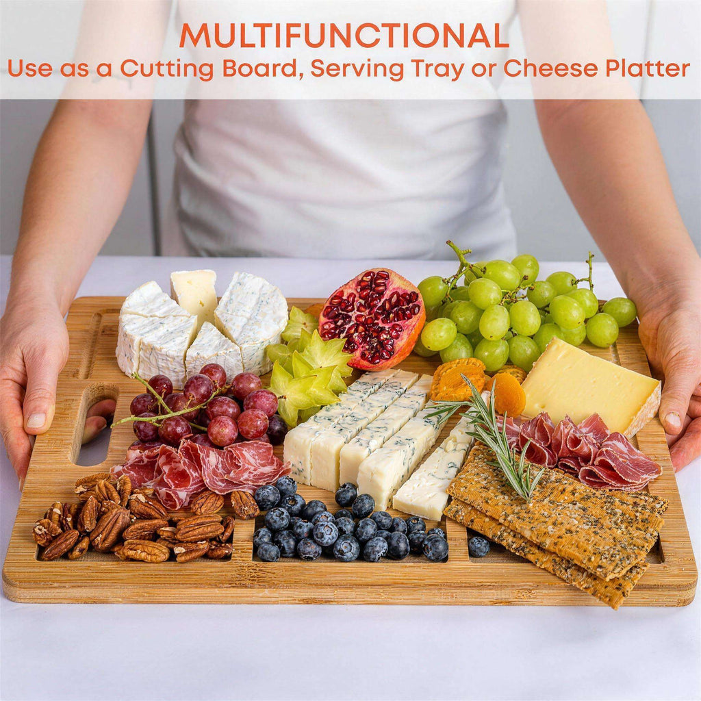 Extra-large bamboo cutting and serving board with juice groove and compartments — in use