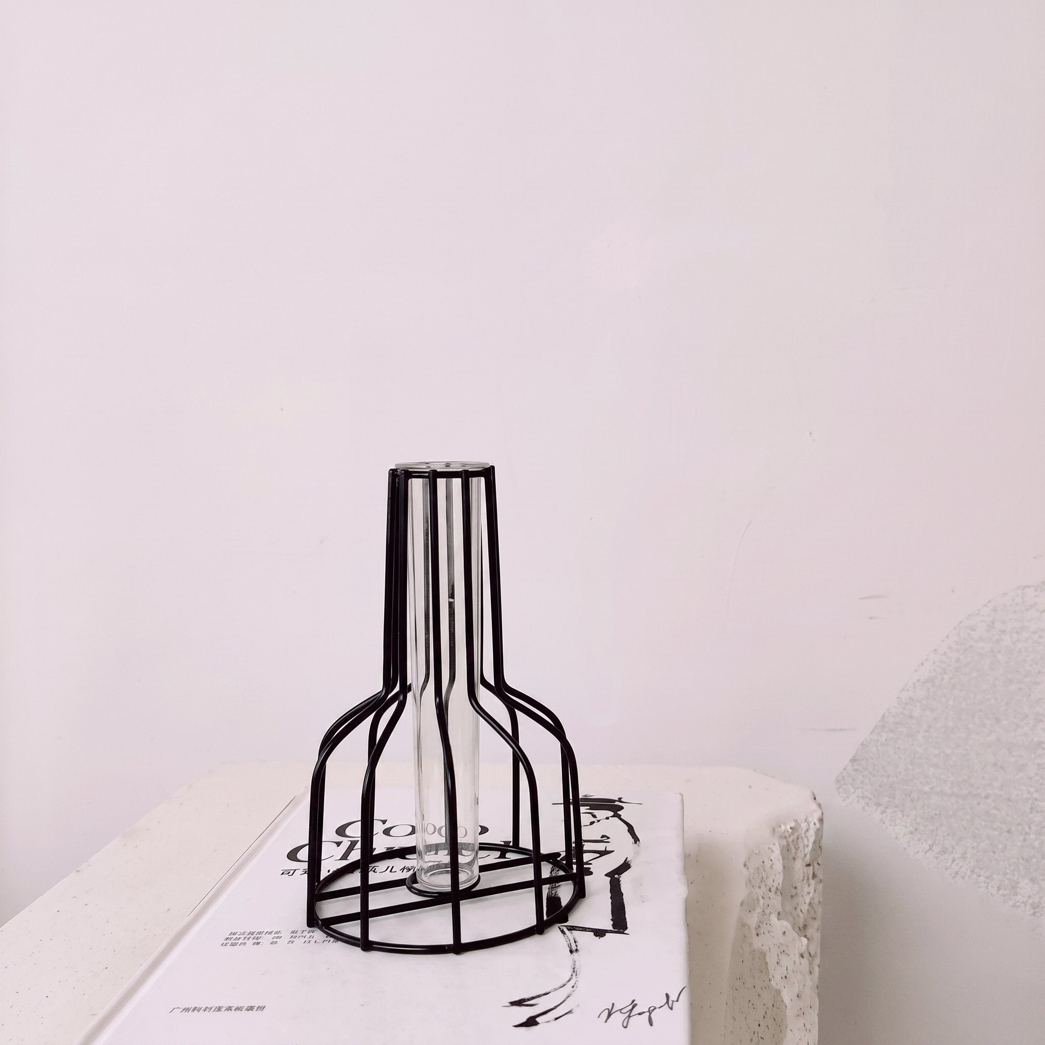Geometric iron bud vase with glass test tube insert holding a single stem — view 6
