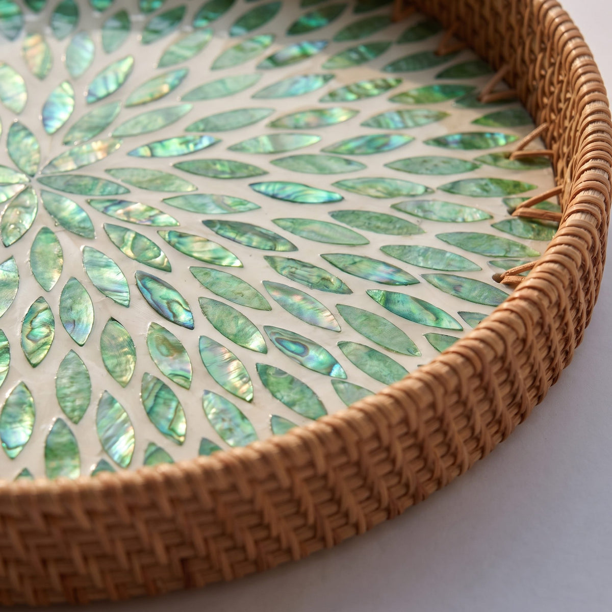 Rattan tray detail showing the mother of pearl inlay against the woven texture
