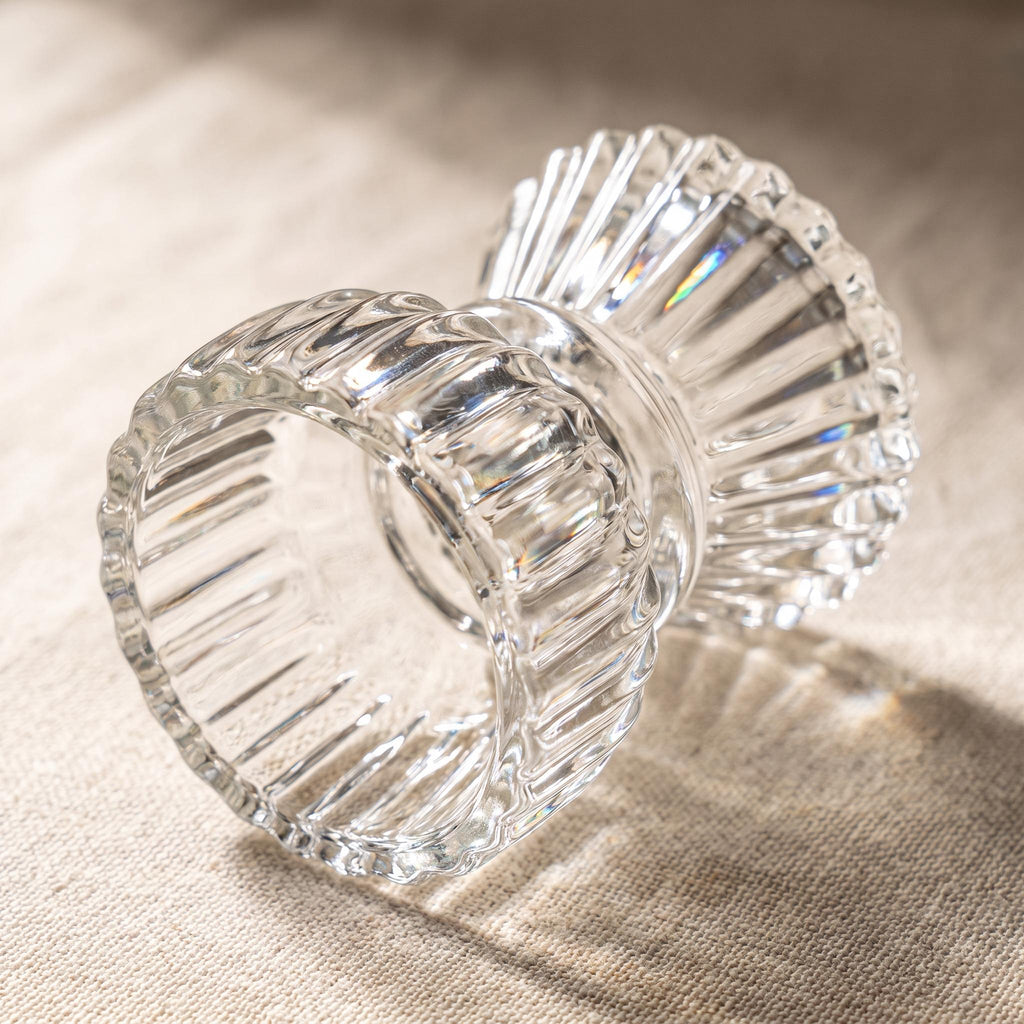 Ribbed glass candle holder detail showing the reversible taper and tealight sides