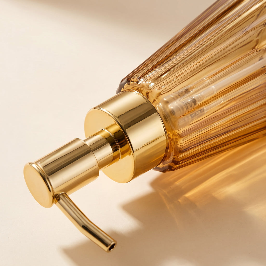 Amber glass soap dispenser detail showing the pump and glass colour