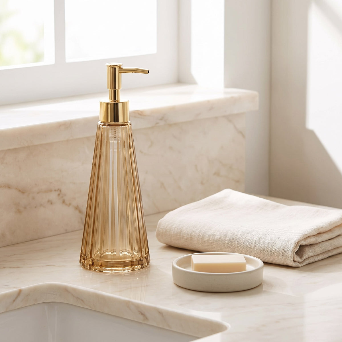 Amber glass soap dispenser on a marble bathroom counter with a linen towel